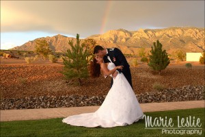 bride and groom with rainbow