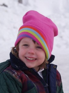 little girl in pink snow hat