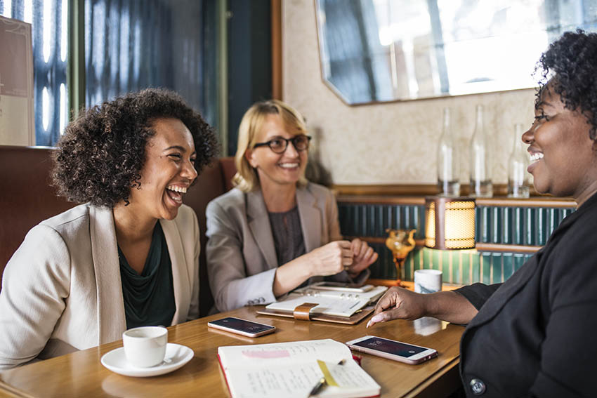 3 diverse women networking happily