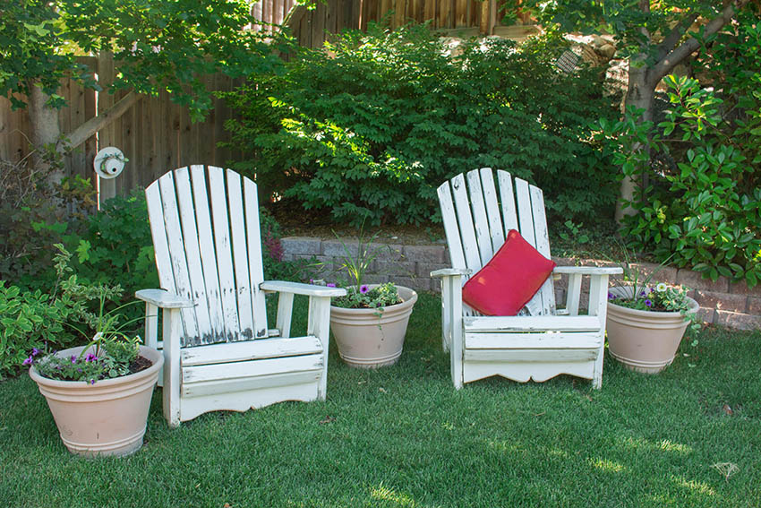 lawn chairs and flowerpots in the garden